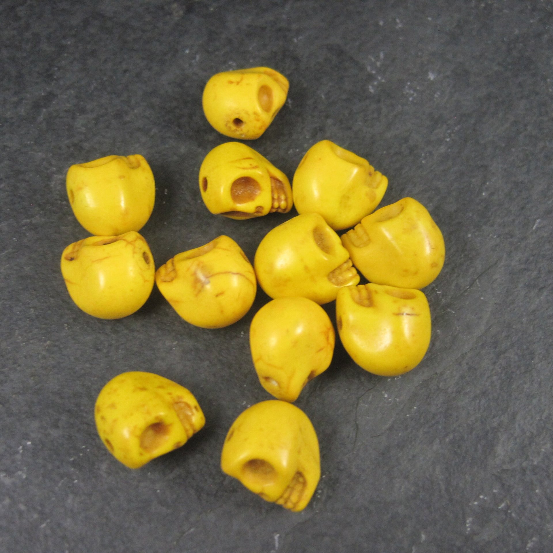 Lot of 12 Yellow Skull Beads 1/2"